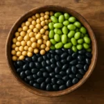 나무 그릇에 노란 콩과 검은 콩, 푸른 콩이 가득 담겨 있는 모습입니다.