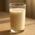 부드러운 아침 햇살을 받고 있는 신선하고 고소한 콩물 한 잔의 모습입니다.